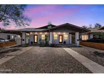 Charming duplex with individual entrances, desert landscaping, and a shared driveway at 1306 E Fillmore St, Phoenix, AZ 85006