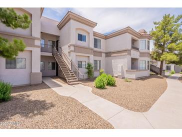 Exterior of condo building with multiple levels, stairwell and desert landscaping at 1941 S Pierpont Dr # 2073, Mesa, AZ 85206
