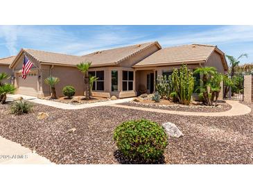 Charming single-story home featuring desert landscaping with an American flag waving in the front at 3930 E Colonial Dr, Chandler, AZ 85249