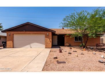 Charming single-story brick home with a well-kept yard and attached garage at 4420 E Covina St, Mesa, AZ 85205