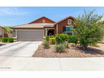 Charming single-story home with a well-maintained front yard and attached two-car garage at 652 E Rojo Way, Gilbert, AZ 85297