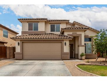 Inviting two-story home featuring a neutral color palette, tile roof, attached garage and low maintenance landscaping at 6637 W Watkins St, Phoenix, AZ 85043