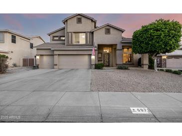 Stunning two-story home with a three-car garage and well-manicured front yard at 6971 W El Cortez Pl, Peoria, AZ 85383