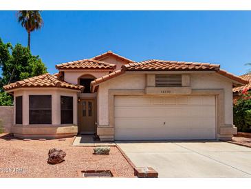 Charming single-story home with desert landscaping, tile roof, and a two-car garage at 18899 N 77Th Ave, Glendale, AZ 85308