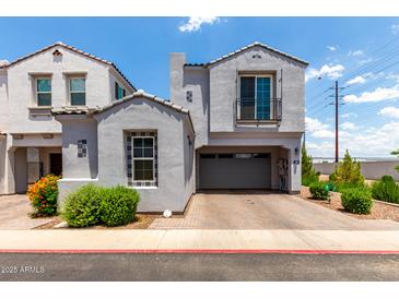 Charming gray two-story home with a two-car garage and beautifully landscaped front yard at 286 E Raleigh Dr, Chandler, AZ 85286