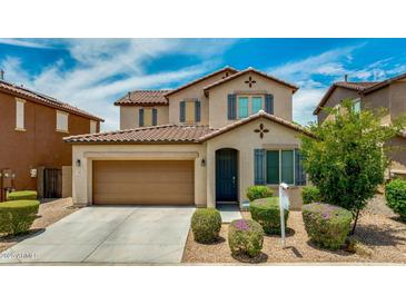 Charming two-story home featuring a well-manicured lawn, a two-car garage, and decorative shutters at 322 N 78Th Pl, Mesa, AZ 85207