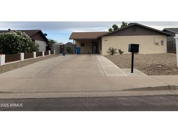 Charming single-story home with a long driveway and low-maintenance desert landscaping at 3229 W Cholla St, Phoenix, AZ 85029