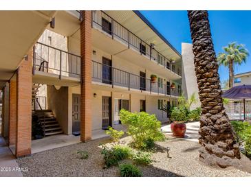 Multi-level building with balconies, landscaped courtyard and staircase access at 4727 E Lafayette Blvd # 211, Phoenix, AZ 85018