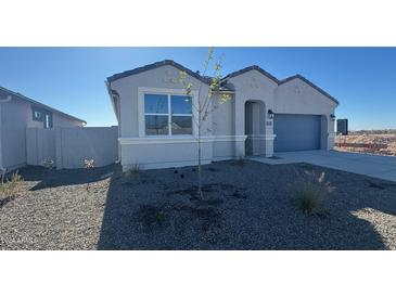 Charming single-story home featuring a modern gray exterior, a two-car garage, and a xeriscaped front yard at 48402 N Duran Way, Gold Canyon, AZ 85118