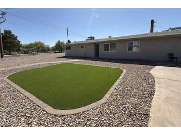 Charming home featuring a low maintenance desert landscape and artificial grass at 5042 S 22Nd St, Phoenix, AZ 85040