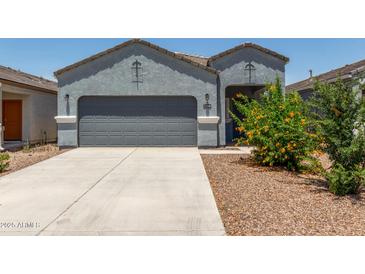 Charming single-story home featuring a well-manicured front yard and two-car garage at 5240 E Gummite Dr, San Tan Valley, AZ 85143