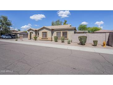 Charming one-story home boasts a low-maintenance front yard and desert landscaping under a clear, sunny sky at 6317 S Kimberlee Way, Chandler, AZ 85249