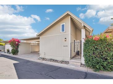 Inviting single-story home featuring desert landscaping, private courtyard, and covered parking at 6629 N Majorca E Way, Phoenix, AZ 85016