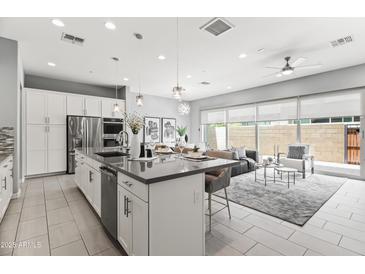 Modern, open-concept kitchen featuring stainless steel appliances and a large island at 7472 E Paraiso Dr, Scottsdale, AZ 85255