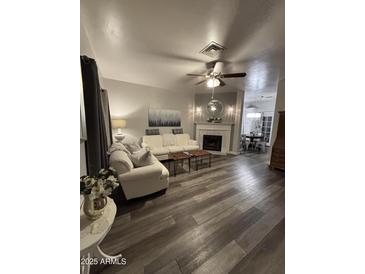 Cozy living room featuring a fireplace and comfortable seating arrangement, perfect for relaxation at 1601 N Saba St # 255, Chandler, AZ 85225