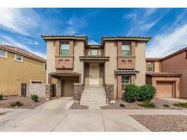 Charming two-story home with attached garage and well-maintained front yard at 1733 N 77Th Dr, Phoenix, AZ 85035
