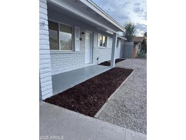 Charming covered front porch with painted brick and new landscaping at 1813 E Boise St, Mesa, AZ 85203