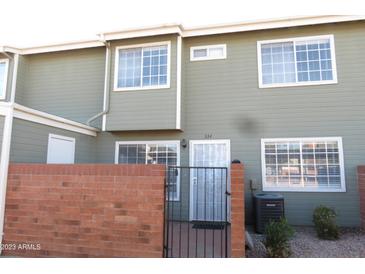 Inviting exterior of a two-story home with fresh paint and a secure gated front entrance at 2301 E University Dr # 334, Mesa, AZ 85213