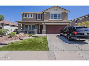 Beautiful two-story home with a well-manicured lawn and attached two-car garage at 29474 W Columbus Ave, Buckeye, AZ 85396