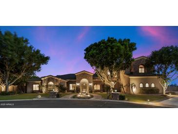 Stunning stone-accented home with a lush, landscaped front yard and charming water feature creates inviting curb appeal at 3523 E Presidio Cir, Mesa, AZ 85213