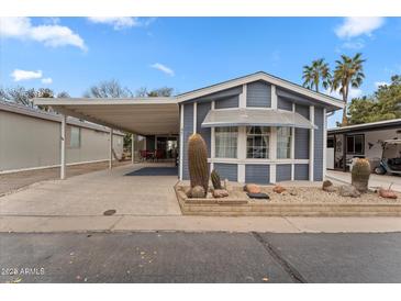 Charming home featuring desert landscaping, a covered carport, and an inviting exterior at 5735 E Mcdowell Rd # 147, Mesa, AZ 85215