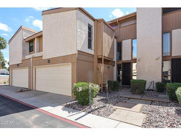 Charming townhouse with a private garage, landscaped walkway, and inviting front entrance at 6533 N 10Th Pl, Phoenix, AZ 85014
