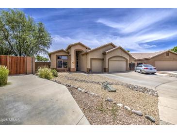 Charming single-story home featuring a two-car garage, neutral stucco, and low maintenance desert landscaping at 863 S Del Rancho --, Mesa, AZ 85208