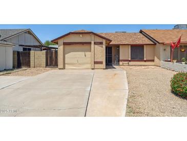 Charming single-story home with a desert landscape and a long driveway at 20644 N 30Th Dr, Phoenix, AZ 85027