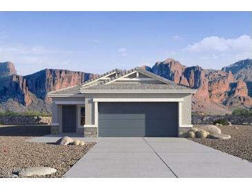Charming single-story home featuring a gray color scheme, two-car garage, and beautiful mountain views at 2067 W Sheridan Ave, Apache Junction, AZ 85120