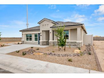 Charming single-story home featuring desert landscaping, a modern design, and neutral tones for curb appeal at 9331 S Mineros Dr, Apache Junction, AZ 85120