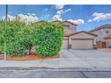 Two-story home with a three-car garage and mature desert landscaping on a sunny day at 10613 E Knowles Ave, Mesa, AZ 85209