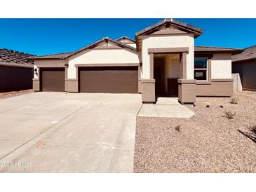 Charming single-story home featuring a two-car garage and a desert-landscaped front yard at 12247 E Agave Ln, Florence, AZ 85132