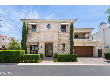 Charming stone home with manicured landscaping, elegant architectural details, and a spacious driveway at 3511 N 39Th Pl, Phoenix, AZ 85018