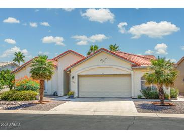 Charming single-Gathering home with desert landscaping and a two-car garage, red tile roof, and neutral stucco exterior at 6301 S Tournament Ln, Chandler, AZ 85249