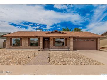 Charming single-story brick home with a well-manicured front yard and two-car garage at 9414 N 50Th Dr, Glendale, AZ 85302