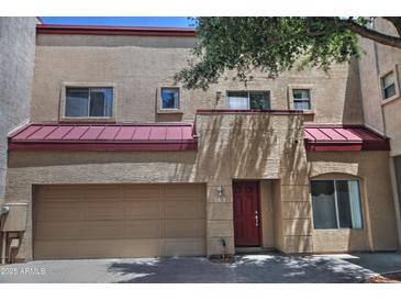 Two-story stucco home with red roof and two car garage at 1015 S Val Vista Dr # 52, Mesa, AZ 85204