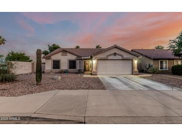 Charming single-story home featuring a well-maintained front yard and attached two-car garage at 11361 E Escondido Ave, Mesa, AZ 85208