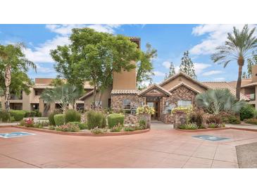 Beautiful community center exterior features stone accents, lush landscaping, and well-maintained grounds at 14145 N 92Nd St # 2011, Scottsdale, AZ 85260