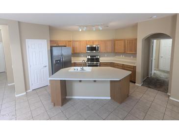 Open kitchen with a large island, stainless steel appliances, and ample counter space at 14841 W Desert Hills Dr, Surprise, AZ 85379