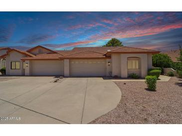 Inviting single-story home with a three-car garage and desert landscaping at 2055 N 56Th St # 15, Mesa, AZ 85215