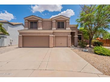 Charming two-story home with a three car garage and well-maintained front yard at 33055 N Madison Way Dr, San Tan Valley, AZ 85144