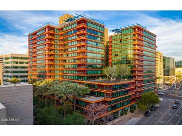 Modern building featuring walls of windows, unique terraces, and lush landscaping at 4808 N 24Th St # 528, Phoenix, AZ 85016