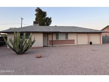 Charming single story home featuring a two car garage and desert landscaping at 1019 E Granada Ave, Apache Junction, AZ 85119