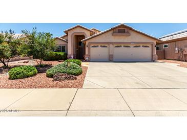Charming single-story home featuring a spacious driveway, desert landscaping, and a two-car garage at 11023 W Chino Dr, Peoria, AZ 85373
