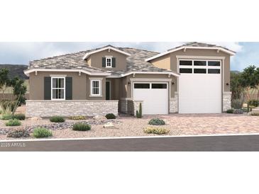 Inviting single-story home featuring a three-car garage, stone accents, desert landscaping, and a neutral color palette at 18195 W Ashley Dr, Goodyear, AZ 85338