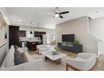 Bright, open-concept living room with modern furnishings and an adjacent kitchen, perfect for entertaining at 3010 N 37Th St # 6, Phoenix, AZ 85018