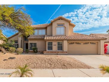 Stunning two-story home featuring a well-manicured front yard, desert landscaping and tile roof at 3641 E Park Ave, Phoenix, AZ 85044