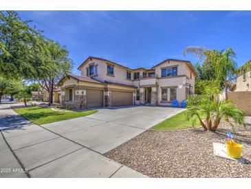 Beautiful two-story home featuring a spacious driveway and meticulously maintained landscaping at 4609 E Ironhorse Rd, Gilbert, AZ 85297