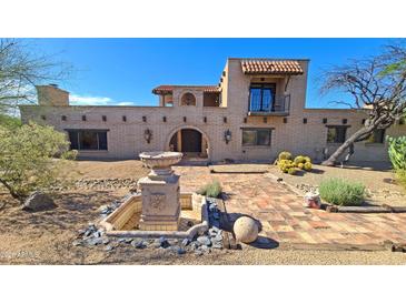 Custom home with brick exterior, fountain, landscaped yard, and desert surroundings at 5141 E Rancho Tierra Dr, Cave Creek, AZ 85331