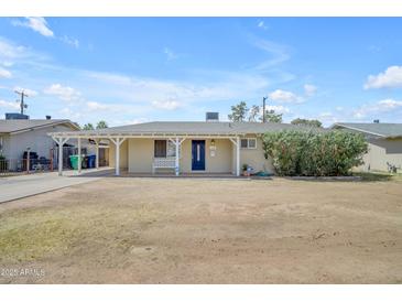 Charming single-story home with a covered front porch and a well-maintained yard in a quiet neighborhood at 1719 E Dana Ave, Mesa, AZ 85204